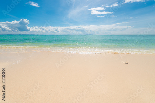 fine sand on the beach, calm azure sea and beautiful clouds on a sunny day idealistic landscape