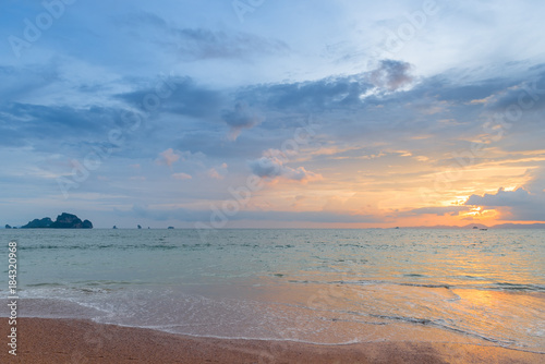 beautiful orange and pink sky during sunset over the calm sea in the resort of Thailand
