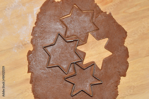 Cutting Christmas gingerbread with metal cutters - stars