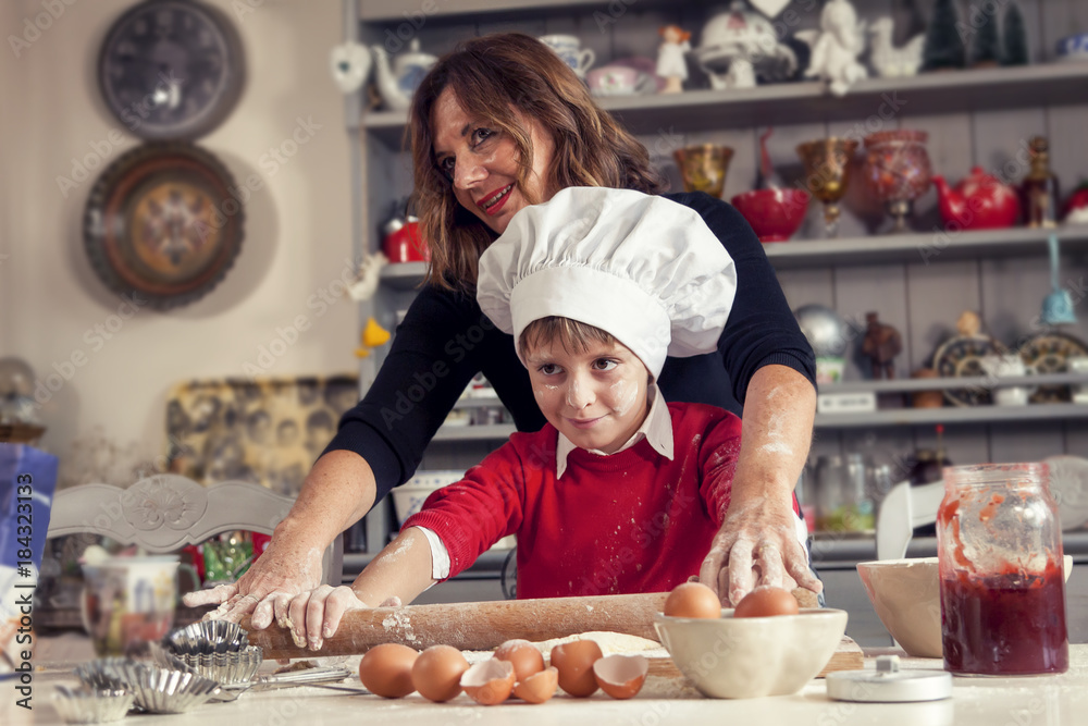 mom helping her son prepare sweet food mom helping her son prepare sweet food