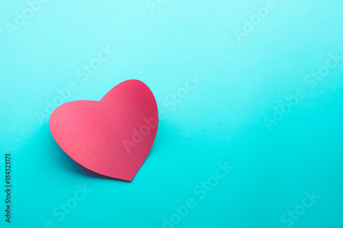 Red paper heart shape on blue background.love,.valentine,wedding concepts