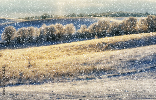 winter field. snowfall on a hilly field