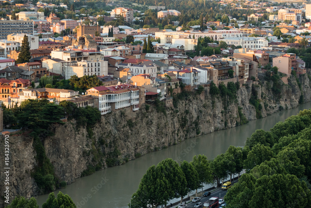 Arial view at the banks of an old city of Tbilisi, capital of Georgia, on the river Kura at sunset.