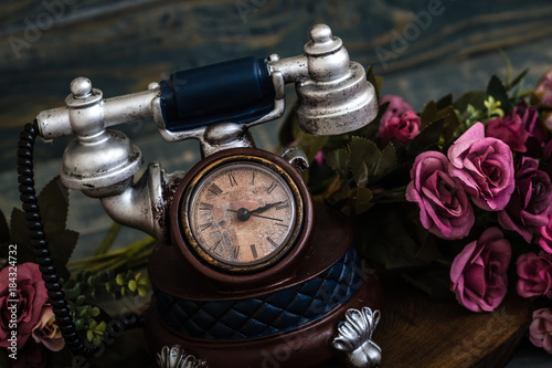 Desk Clocks with Antic Telephone Shape on Blue Background photo