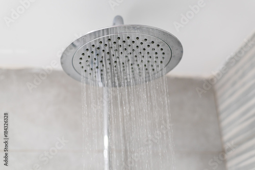 Home shower head closeup, raindrop flow model, spilling water