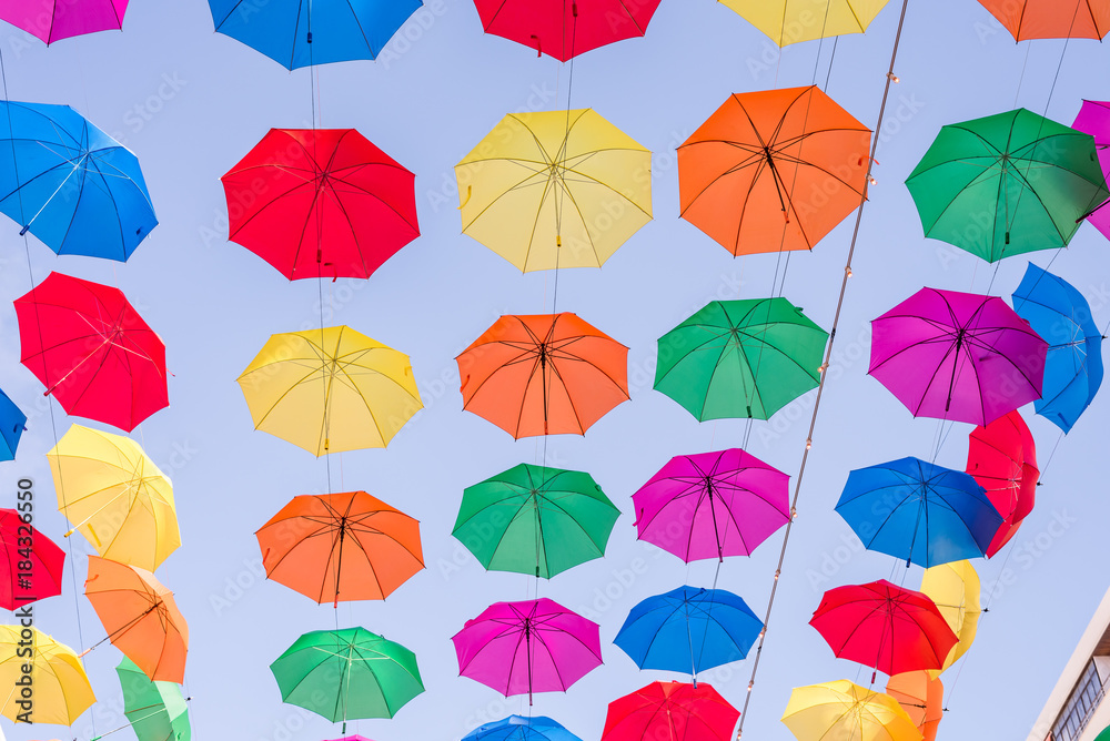 A field of open multi colored umbrellas used as sun protection at a public place somewhere at Torremolinos, Spain (different views) A field of open multi colored umbrellas used as sun protection at a public place somewhere at Torremolinos, Spain (different views)