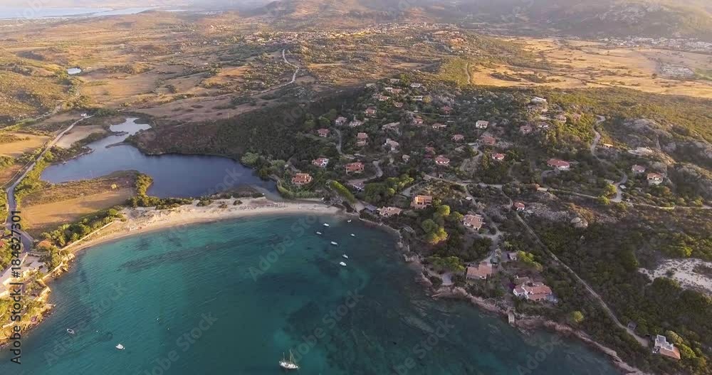 Aerial, beautiful bay in Sardinia island and few ancored yachts on sunset, 4K