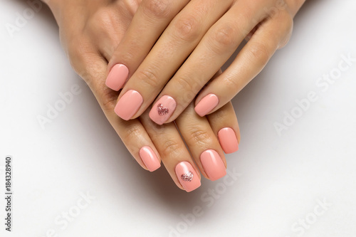 pink manicure with golden hearts on nameless fingers on short nails

