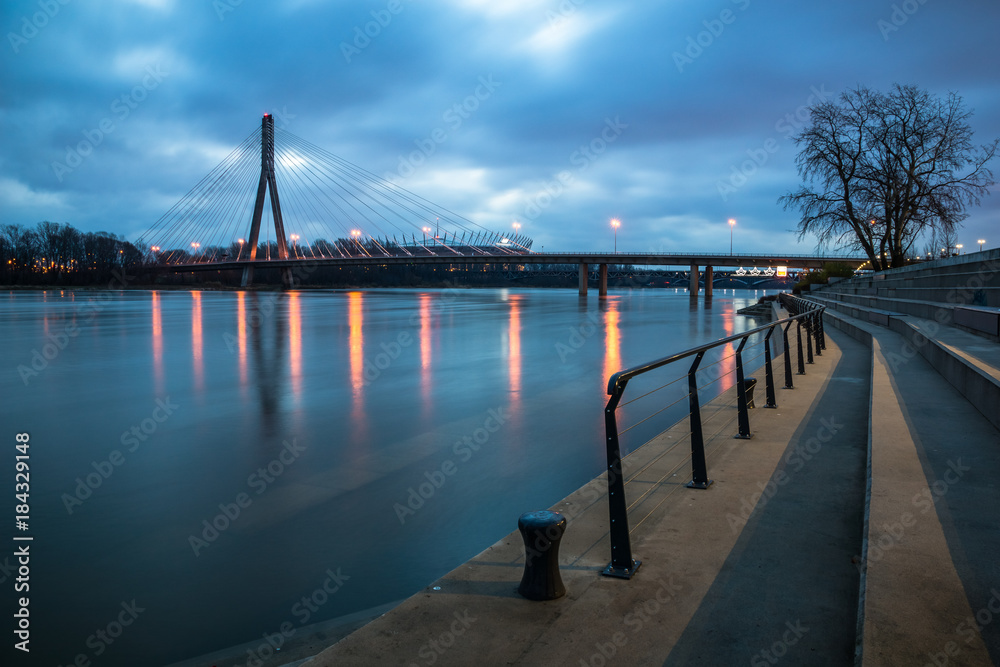 Dawn on the Swietokrzyski bridge over the Vistula river and boulevards in Warsaw, Poland