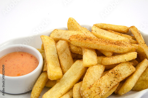 potato fries and sauce on the plate on the white background