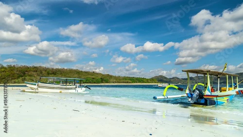 Timelapse Boat on the beach with turquoise water on the Gili Nanggu, Lombok, Indonesia photo