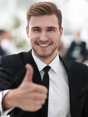 portrait of happy businessman showing thumb up.