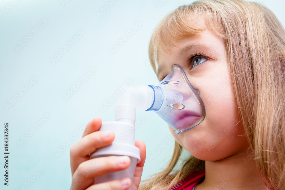 Portrait of sweet little girl using an inhaler Portrait of sweet little girl using an inhaler