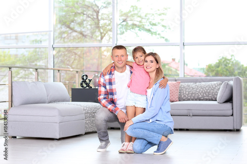 Happy family in room at new...