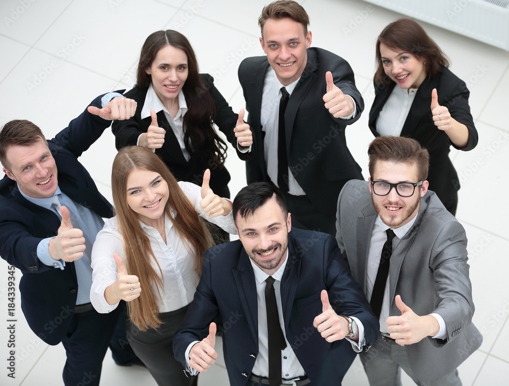 successful business team holding up a thumbs up successful business team holding up a thumbs up