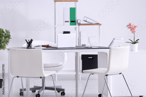 Modern office interior with table and white chairs © Africa Studio