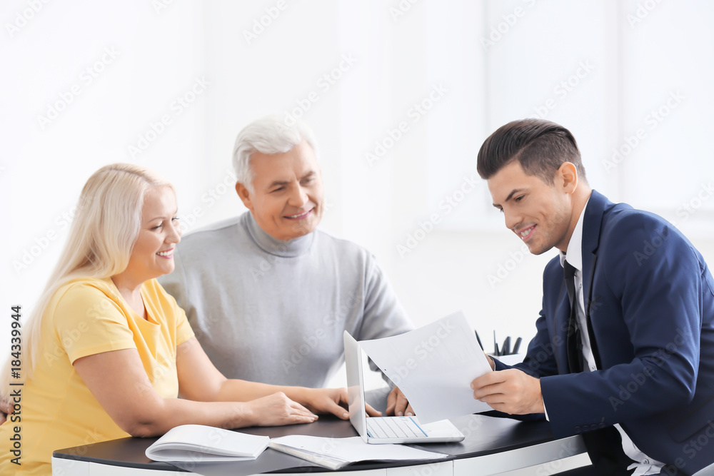 Senior couple meeting with consultant in office Senior couple meeting with consultant in office