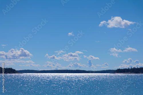 Glittering sea and blue sky at the island Aaland, part of Finland in northern Europe photo