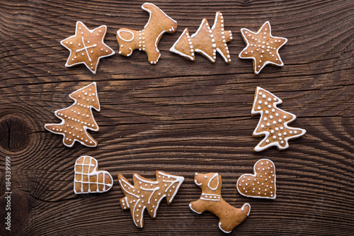 Gingerbread Christmas cookie background. Christmas homemade gingerbread cookies on wooden background.