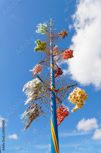 Maypole to celebrate Midsummer decorated with colorful ribbons, typical design from Aaland, part of Finland in northern Europe photo
