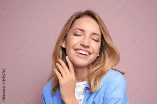 Smiling woman in casual clothes on color background