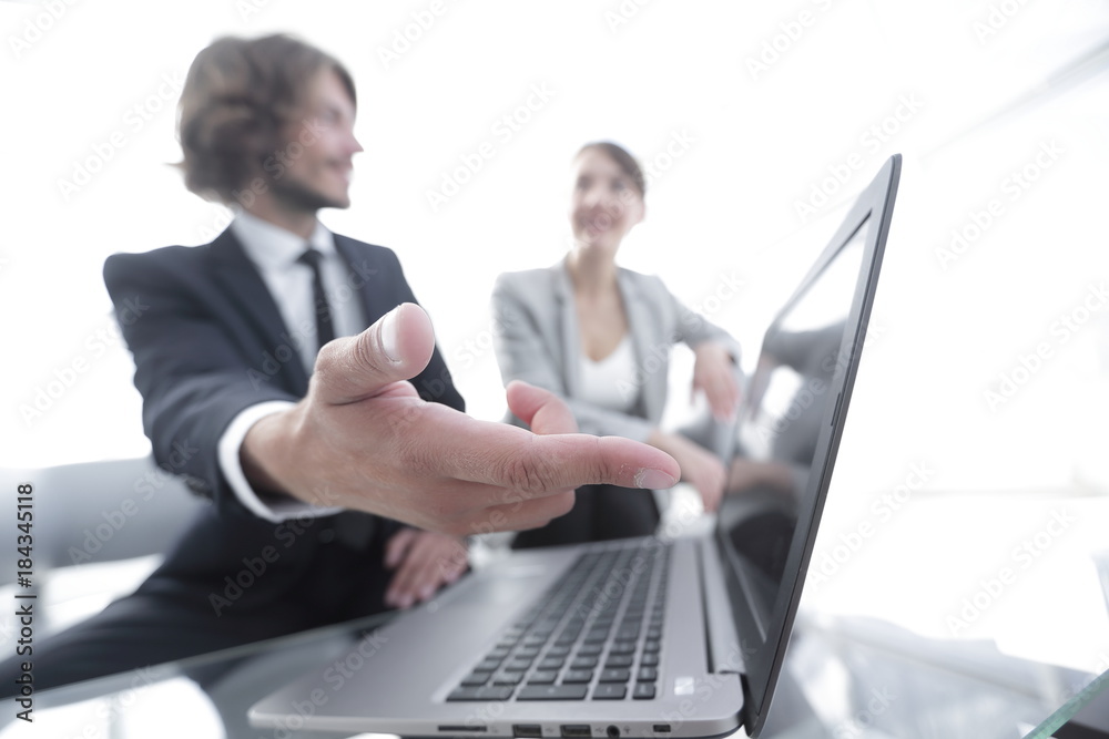 .Employees looking at laptop and talking about work .Employees looking at laptop and talking about work
