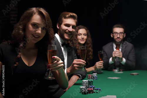 poker players with a glass of wine,sitting at the table