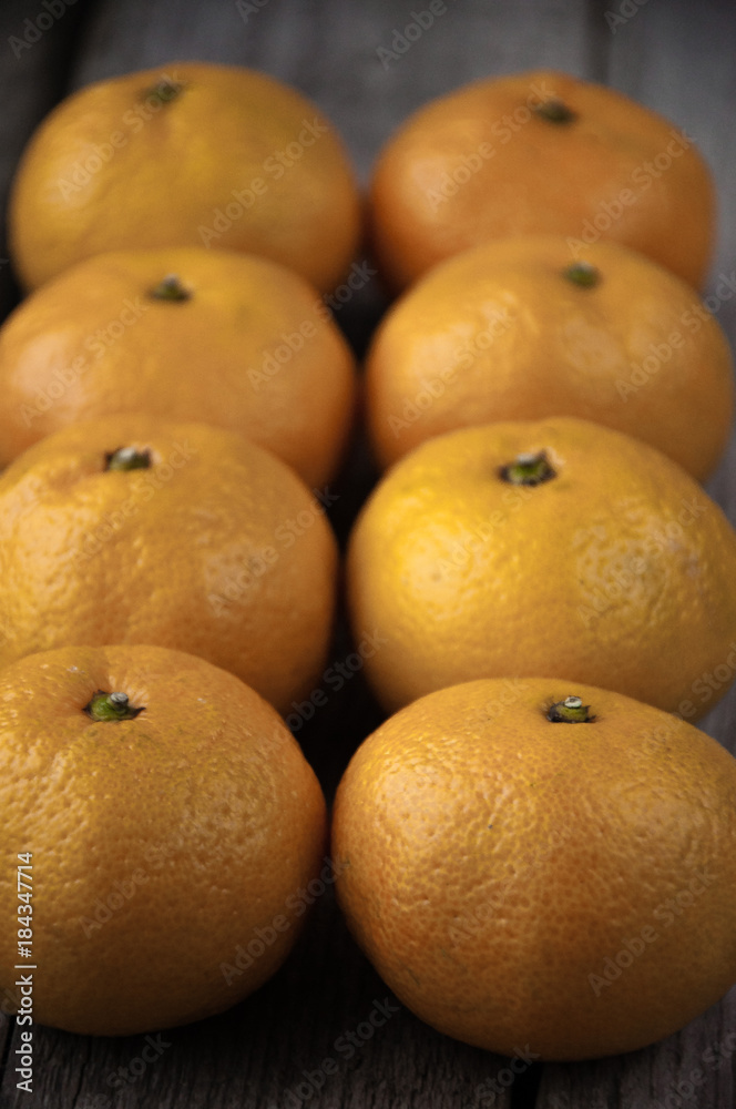 On a wooden background fresh tangerines in two rows On a wooden background fresh tangerines in two rows