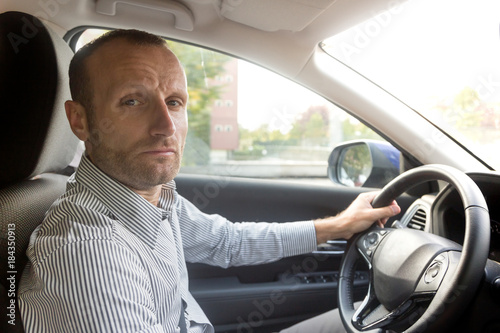 Stressed and annoyed male driver on the road during the rush hour © tostphoto