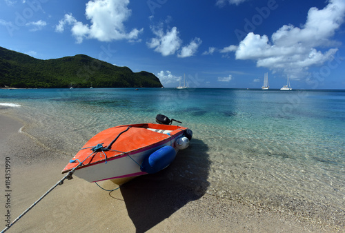 Boat on perfect tropical white sand beach.