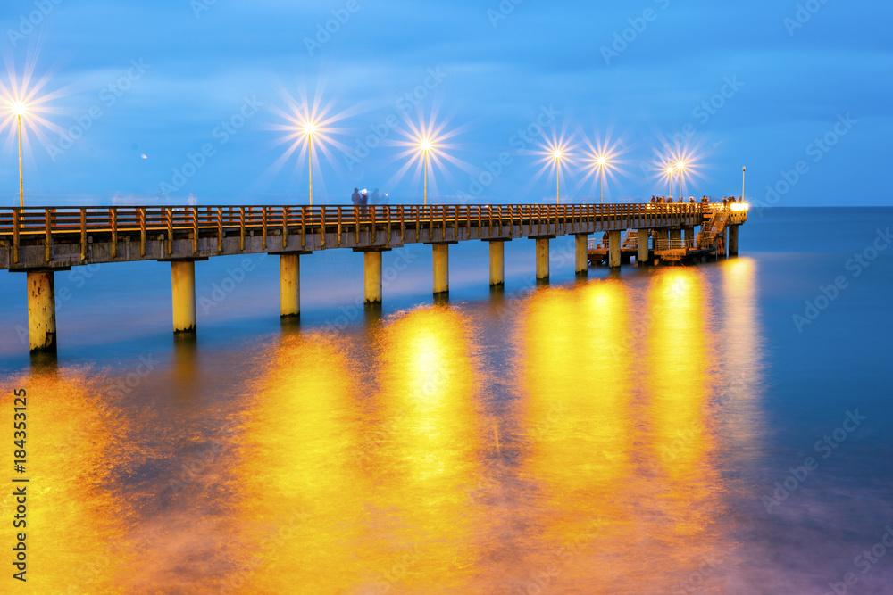 pier and a beautiful cloudy sky above the sea, long exposure