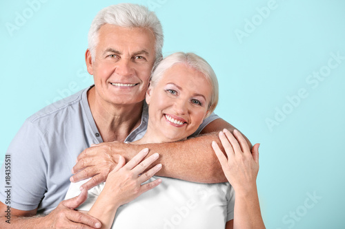 Mature couple against color...