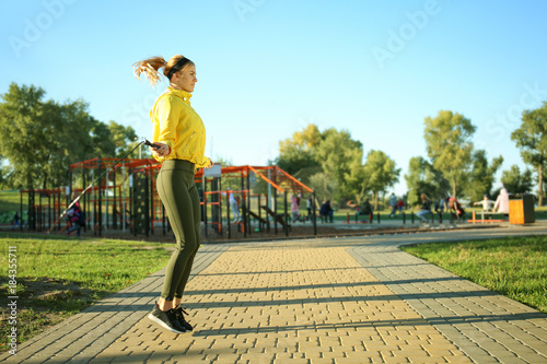 Sporty young woman jumping ...