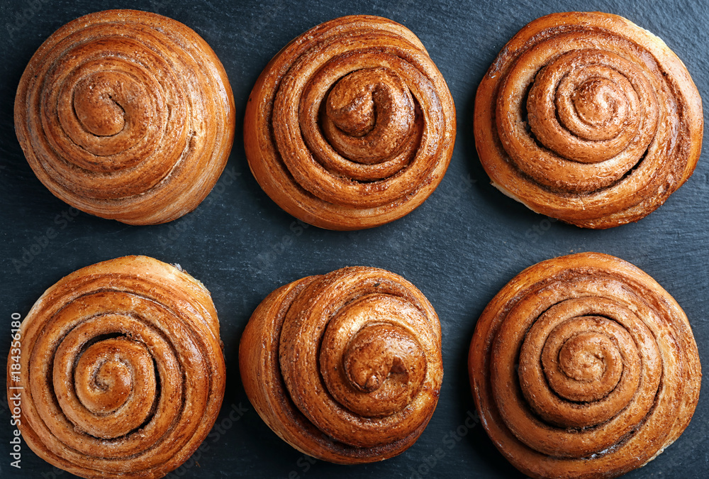 Sweet cinnamon rolls on table