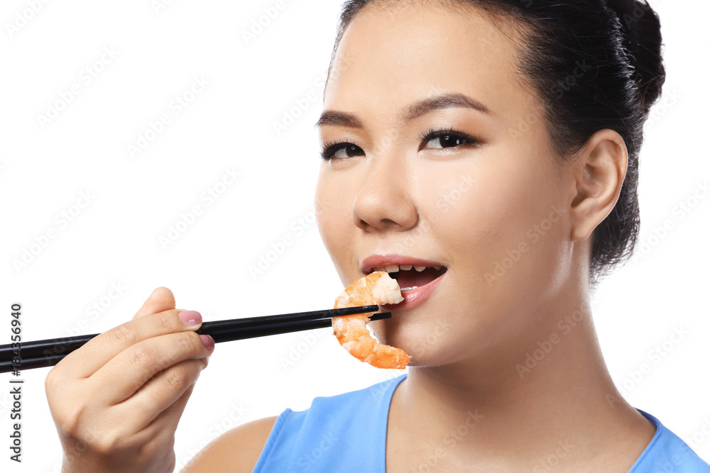 Beautiful Asian woman eating shrimp on white background Beautiful Asian woman eating shrimp on white background