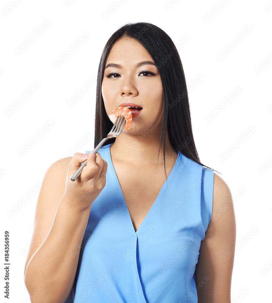 Beautiful Asian woman eating shrimp on white background Beautiful Asian woman eating shrimp on white background