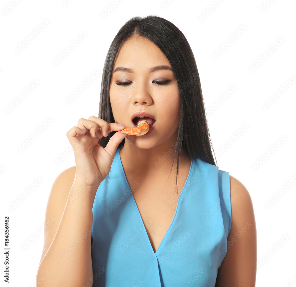 Beautiful Asian woman eating shrimp on white background Beautiful Asian woman eating shrimp on white background