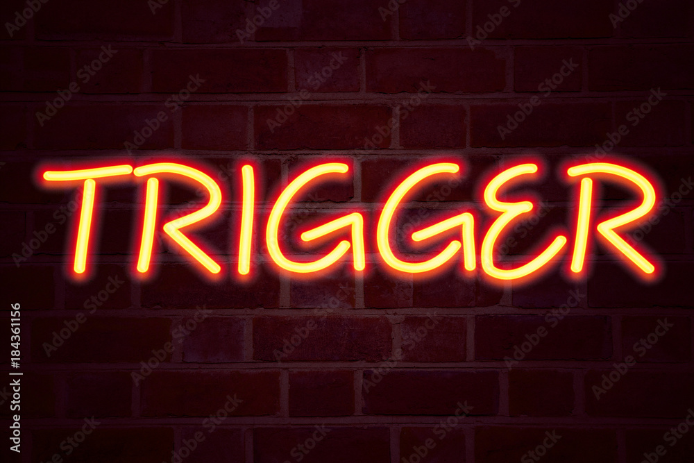 Fototapeta premium Trigger neon sign on brick wall background. Fluorescent Neon tube Sign on brickwork Business concept for Stir Spark Loose or Unleash Idea 3D rendered