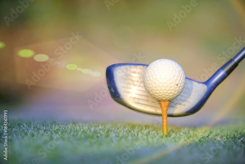 golf ball on wooden tee ready to hit by the wood driver of golf player on the tee oof of the golf course