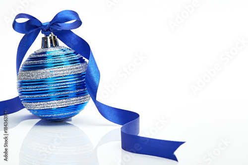 Blue Christmas ball with ribbon bow on white background photo