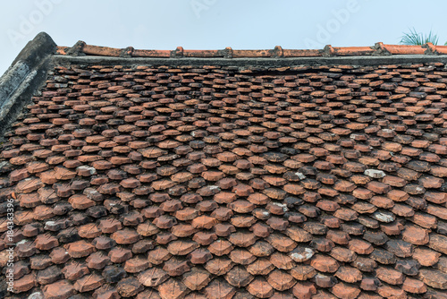 Ancient roof tiles decorative ornaments details of the old building in Vietnam