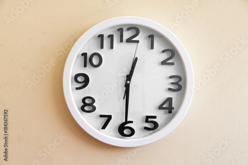 Wall clock on cream color background. 