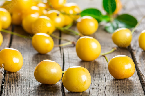 Yellow cherry on a wooden background