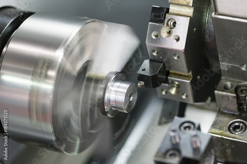 machining automotive part by cnc turning machine photo
