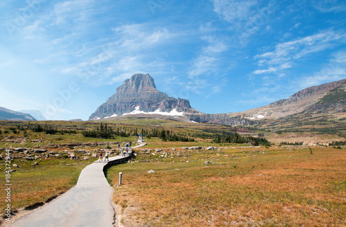 CLEMENTS MOUNTAIN TOWERING ABOVE THE HIDDEN LAKE HIKING TRAIL ON LOGAN PASS UNDER CIRRUS CLOUDS DURING THE 2017 FALL FIRES IN GLACIER NATIONAL PARK IN MONTANA UNITED STATES