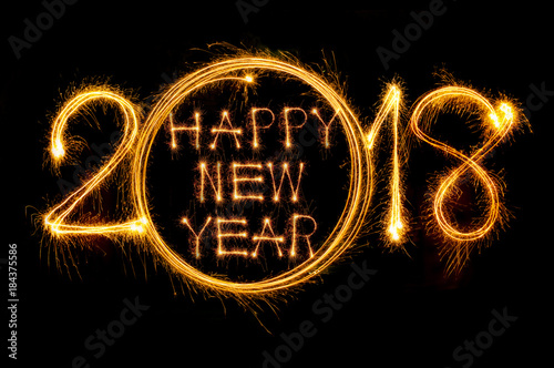 Happy new year 2017 text written with Sparkle fireworks isolated on black background