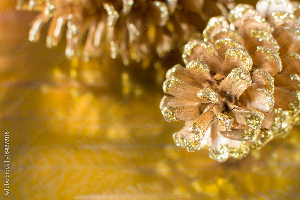 Glitter sparkle gold pine cone Christmas holiday background with copy space Glitter sparkle gold pine cone Christmas holiday background with copy space