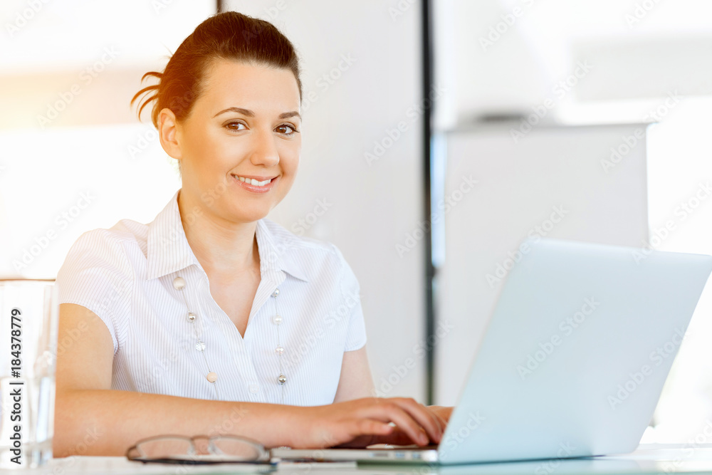 Portrait of businesswoman working at computer in office Portrait of businesswoman working at computer in office