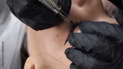 Beautician, specialist of permanent make-up making eyeliner permanent make up