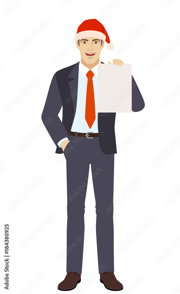 Businessman in Santa hat with hand in pocket showing the blank paper Businessman in Santa hat with hand in pocket showing the blank paper